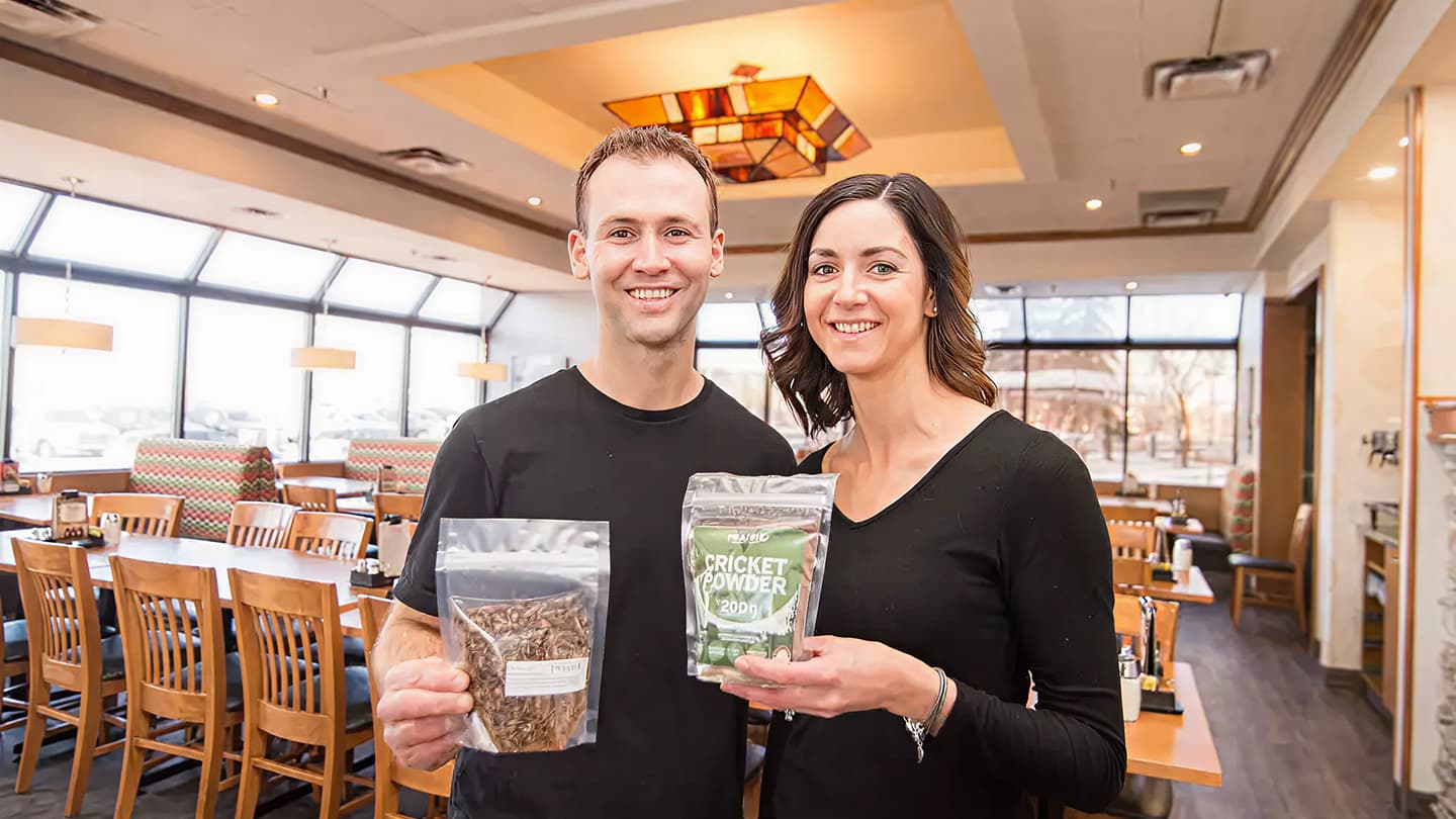 Prairie Cricket Farms founders holding cricket protein powder packages